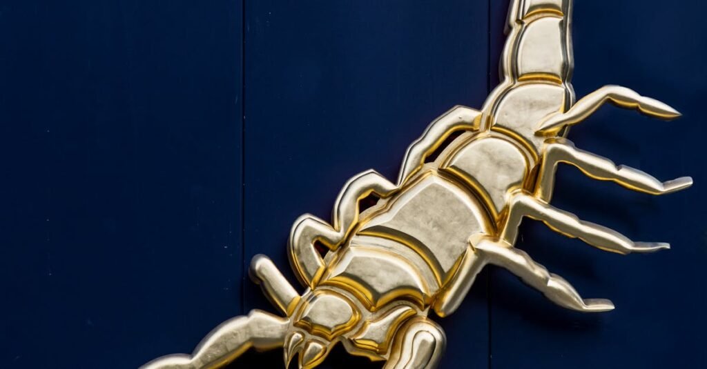 A striking golden scorpion figurine decorates a dark background, perfect for modern interiors.